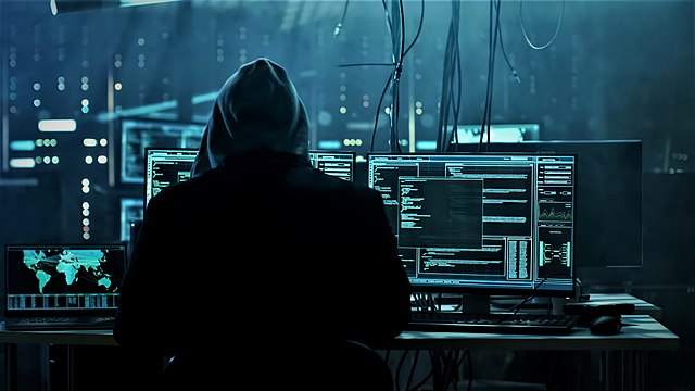 Wallpapersden.com anonymous-hacker-working 1280x720